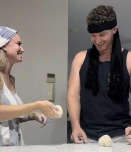 Image of a man and a woman wearing blindfolds playing with Clay Date 1 - Rendé