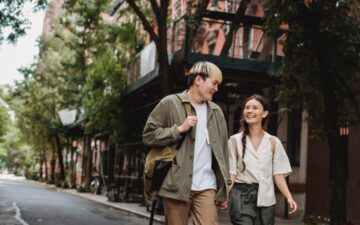 Rende blog photo: man and woman walking holding hands looking at each other.